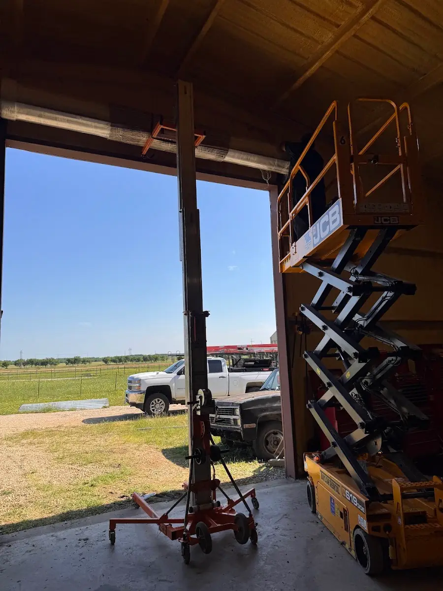 Access equipment inside a tall commercial door opening