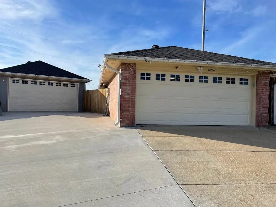 Two white garage doors with matching window layouts
