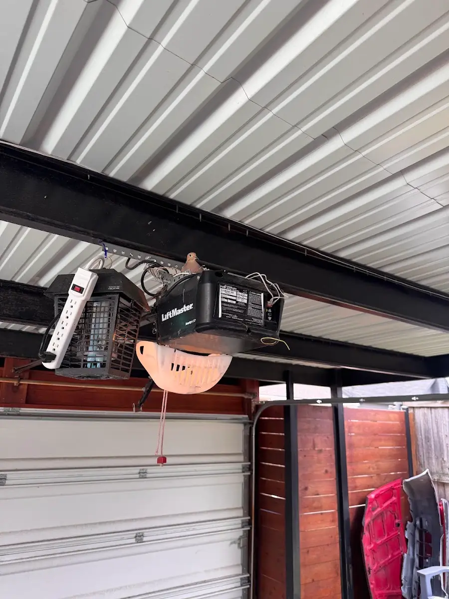 Ceiling-mounted LiftMaster garage door opener with its light illuminated