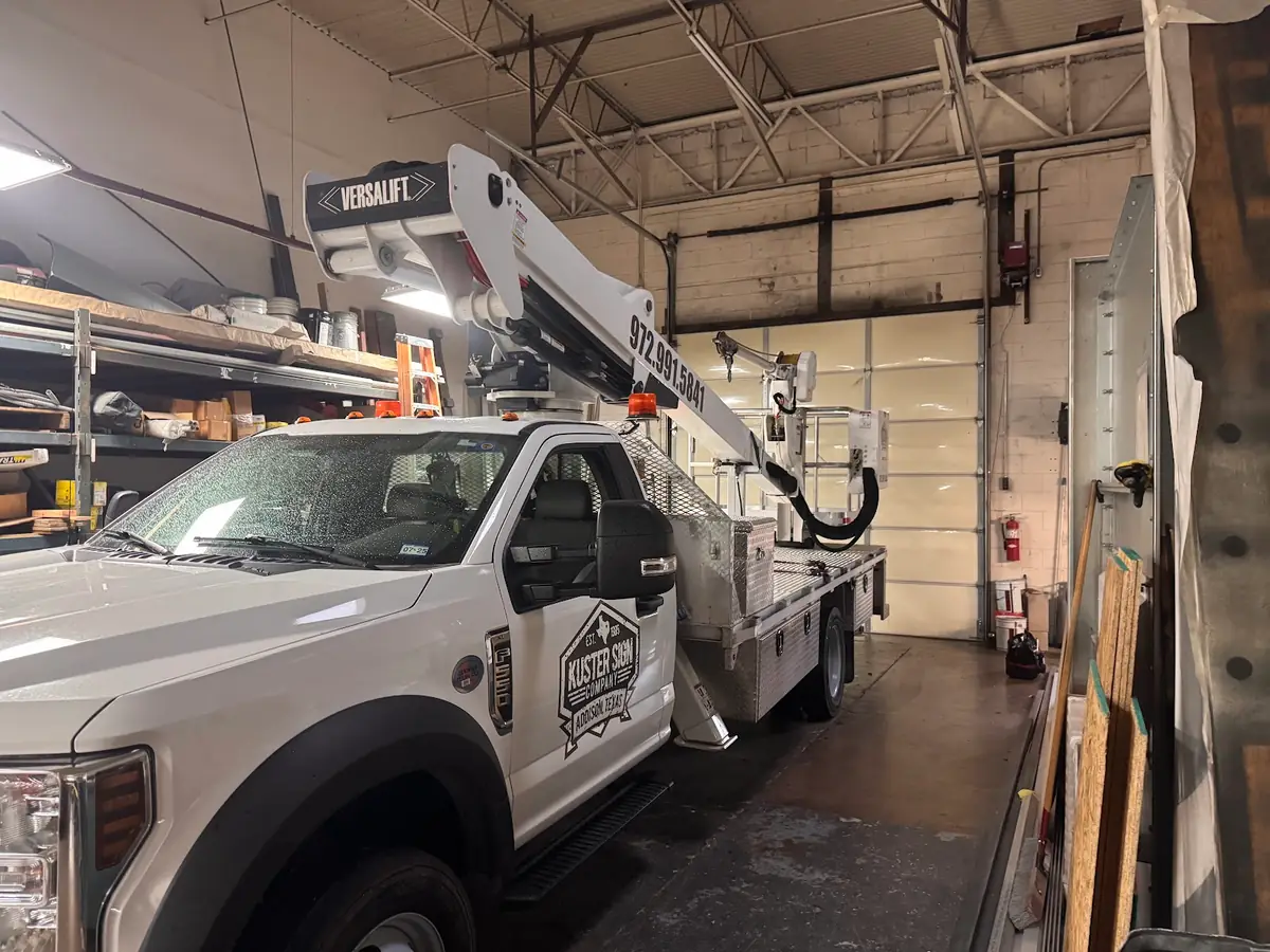 Lindsey service truck inside a workshop with an overhead garage door
